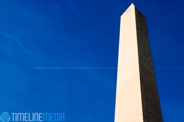 Contrails streaking from the back of plane over the Washington Monument ©TimeLine Media