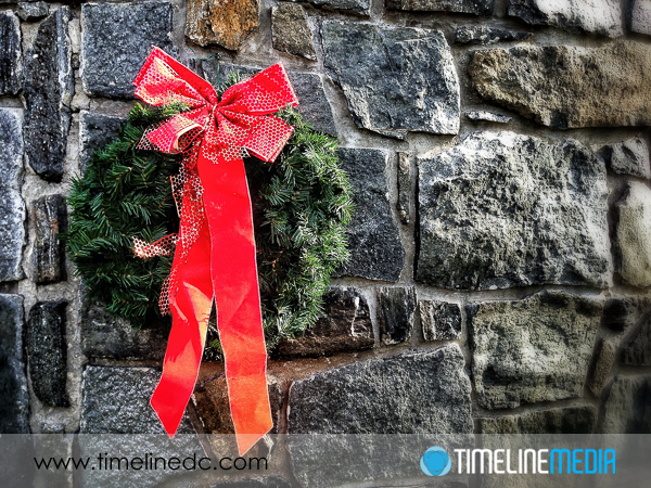 Photography of holiday decor against a stone wall