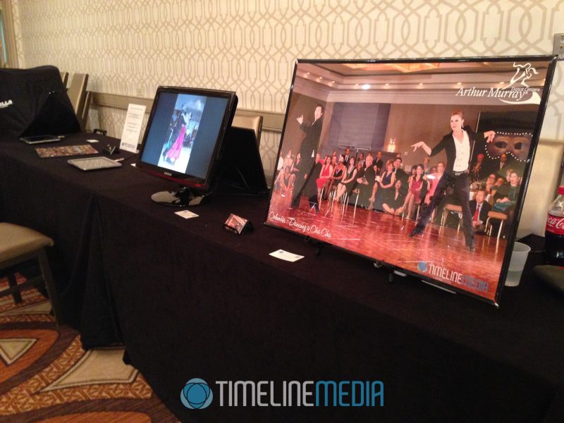 Display monitor with photos from this event in progress, poster from the previous event at our booth ©TimeLine Media