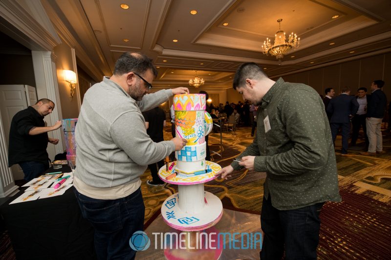 Artists and guests contributing to a Tysons Partnership art piece at the Ritz Carlton ©TimeLine Media