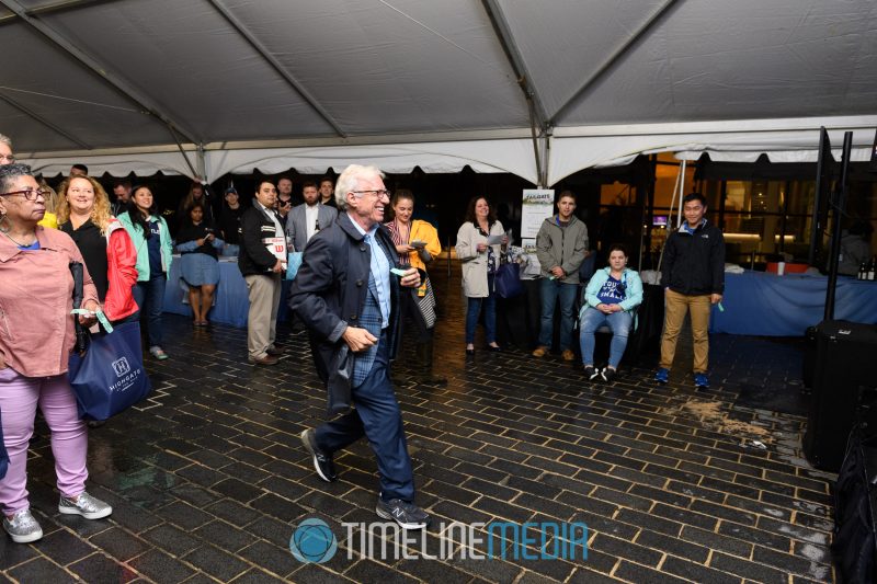 Sol Glasner winning a silent auction prize at the Tysons Tailgate ©TimeLine Media