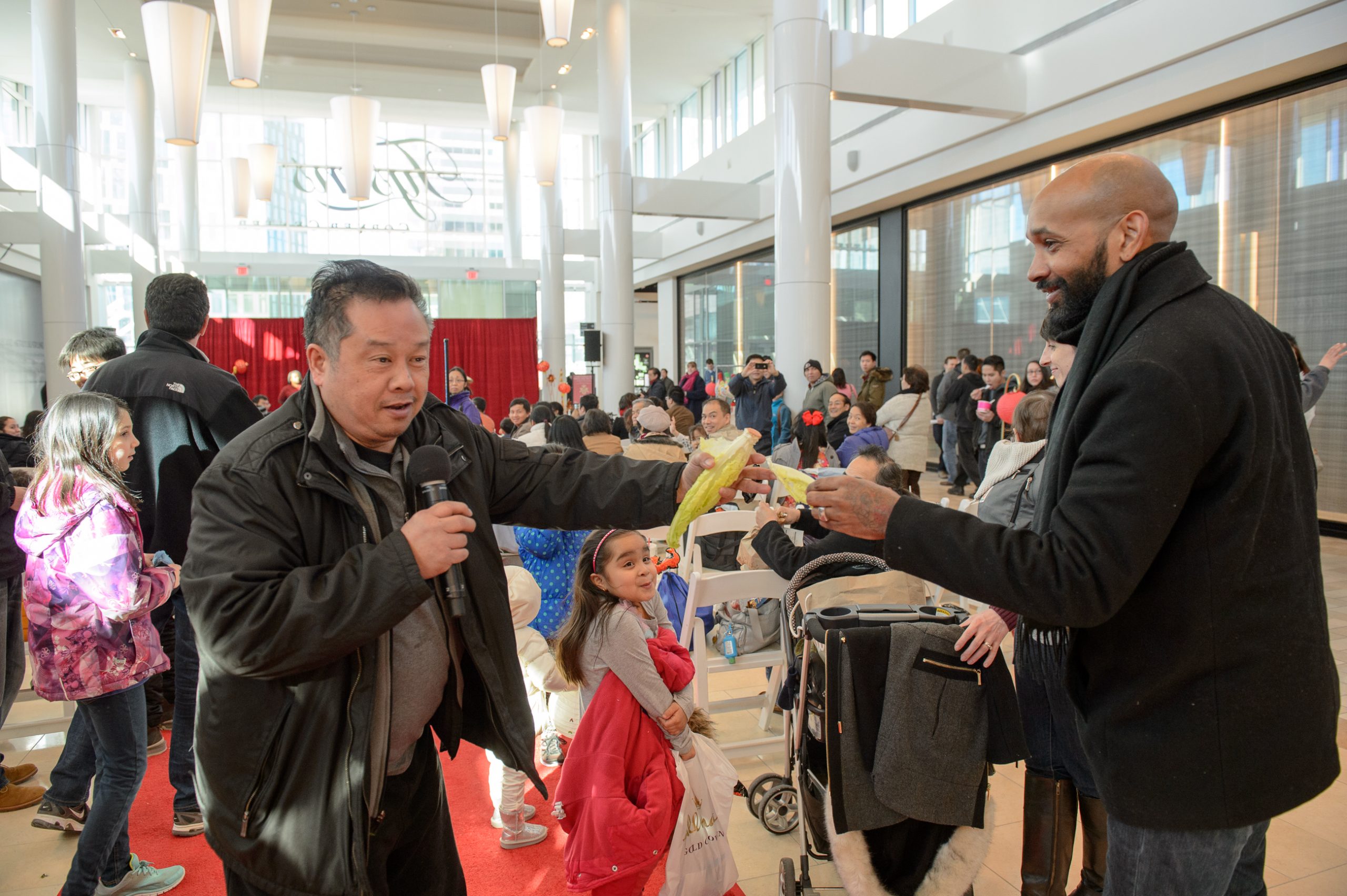 Getting lettuce to feed the dragon at Lunar New Year celebration at the Concourse in Tysons Corner Center