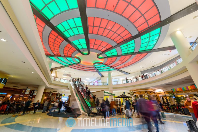 Holiday colored lights above an escalator at Tysons Corner Center on Black Friday