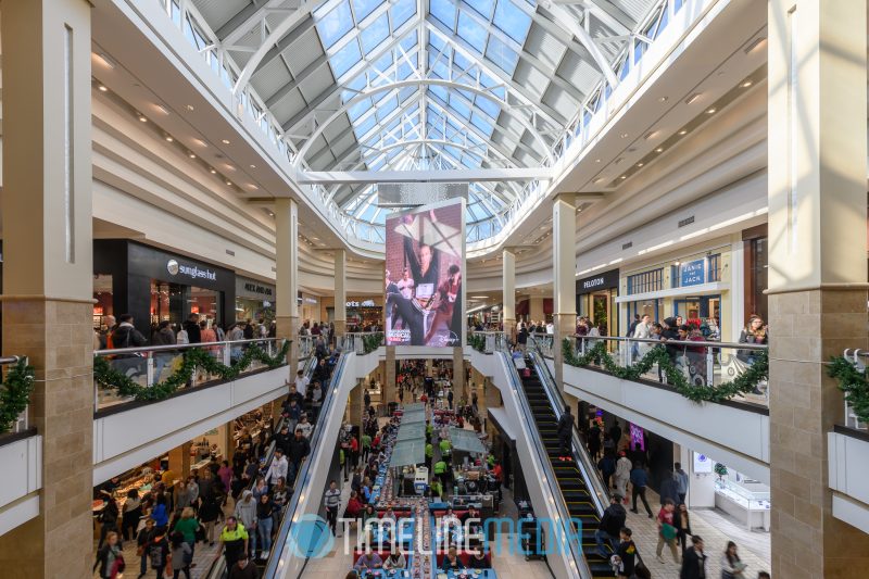 Digital board in Aviary Court at Tysons Corner Center crowded with shoppers