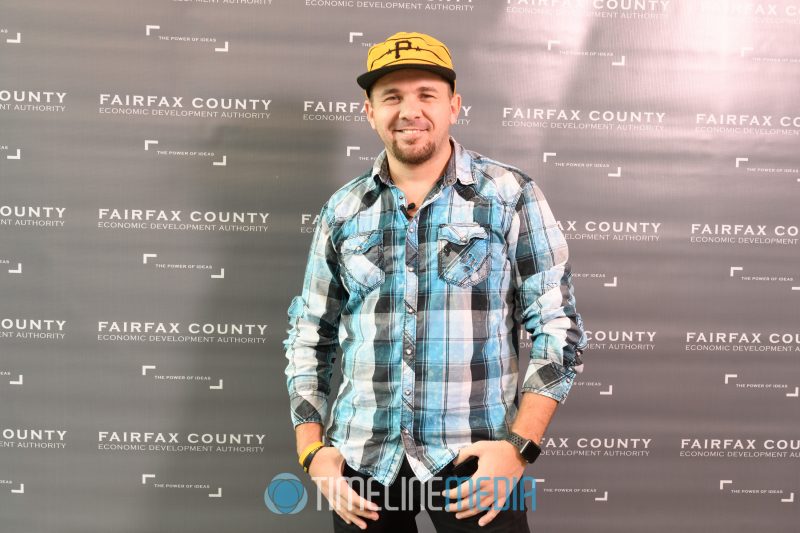 Brian Fanzo in front of the FCEDA step and repeat - SWMi Fairfax event ©TimneLine Media