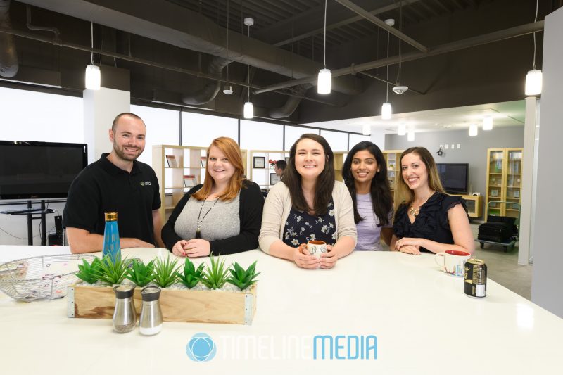 Team photo of Virid staff in the kitchen area of their Reston, VA office ©TimeLine Media