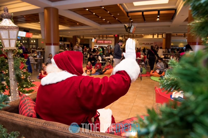 Santa waving to kids during the show at the Santa Breakfast at Tysons Corner Center