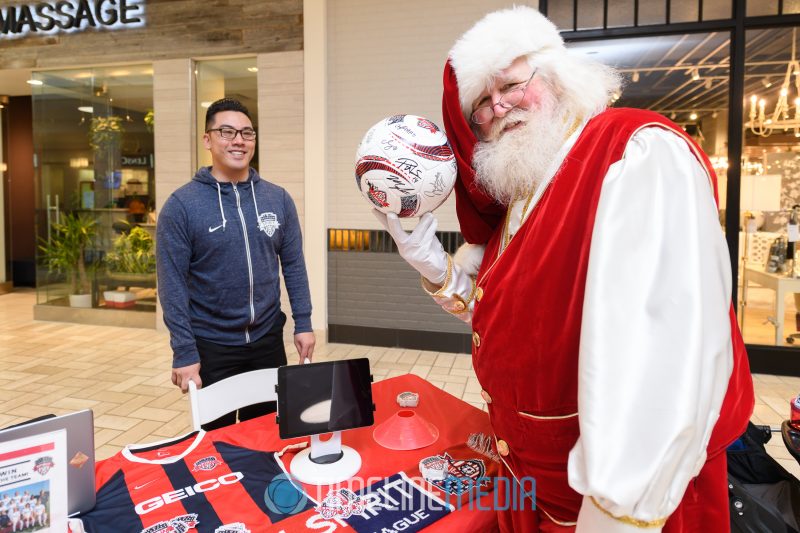 Holding a soccer ball from the Washington Spirit at their booth in Tysons Corner Center 2019 Athleta Holiday Yoga